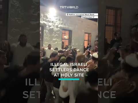 Israeli settlers dance at holy site in occupied West Bank